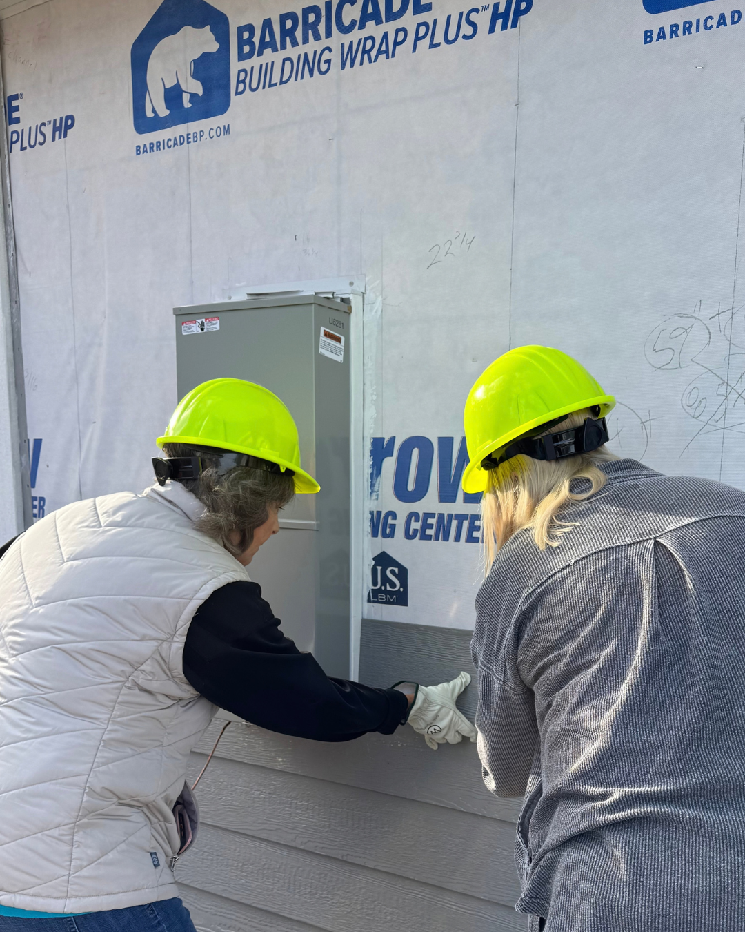 Employees installing siding